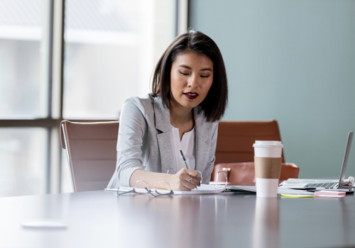 HR professional taking notes in meeting room